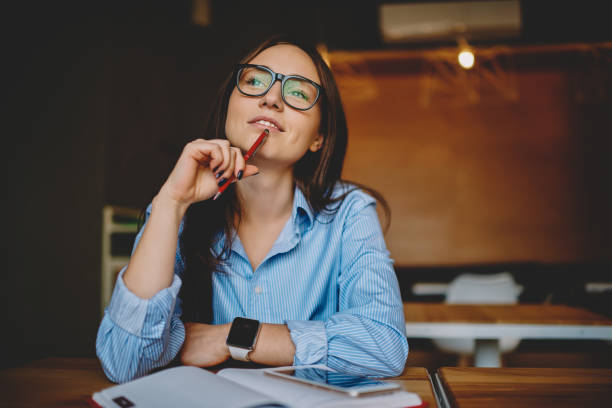 A woman reviewing notes and preparing questions before a PRF appointment