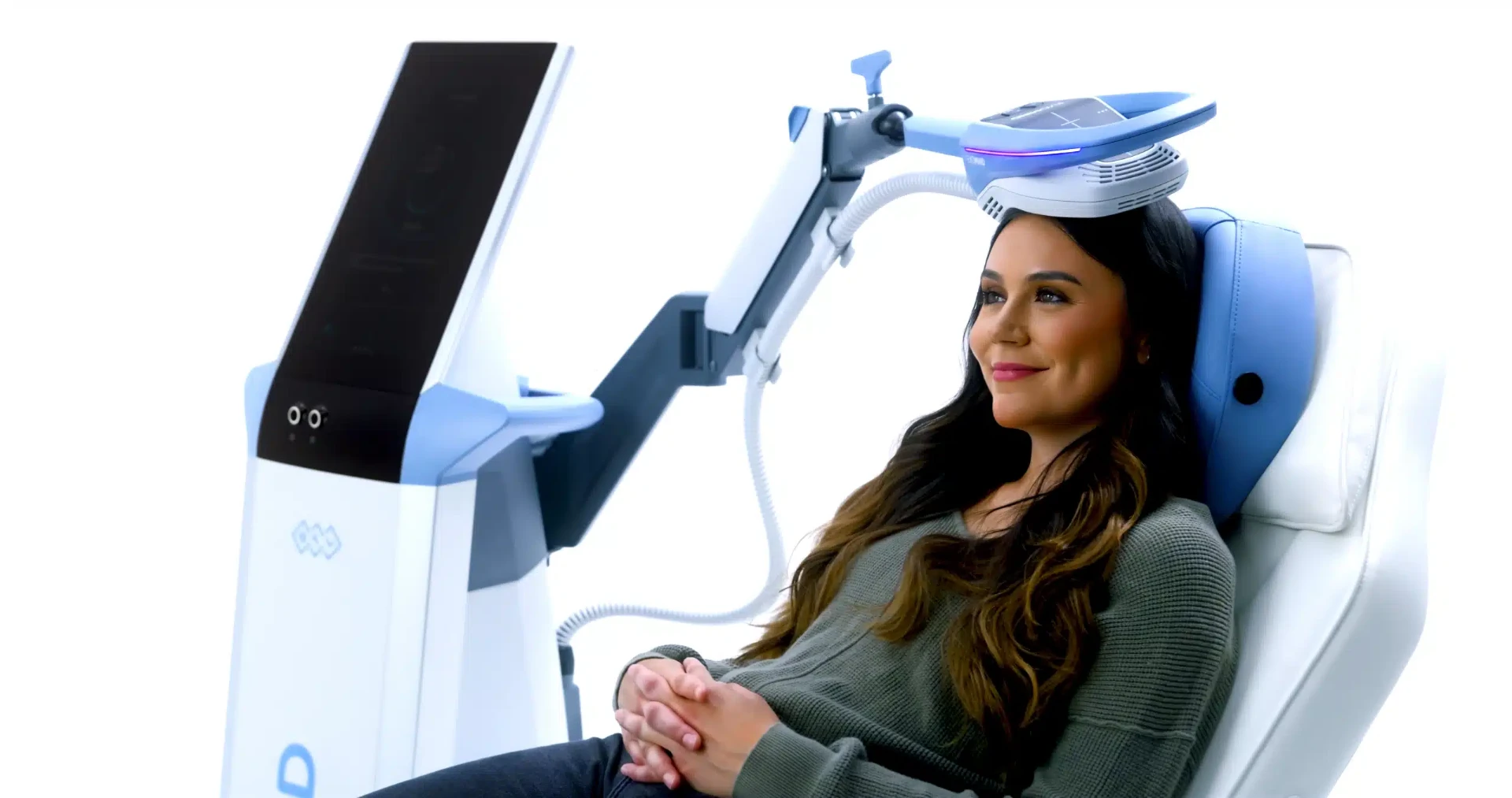 Woman relaxing during an EXOMIND session with the ExoTMS neuromodulation device positioned at the forehead